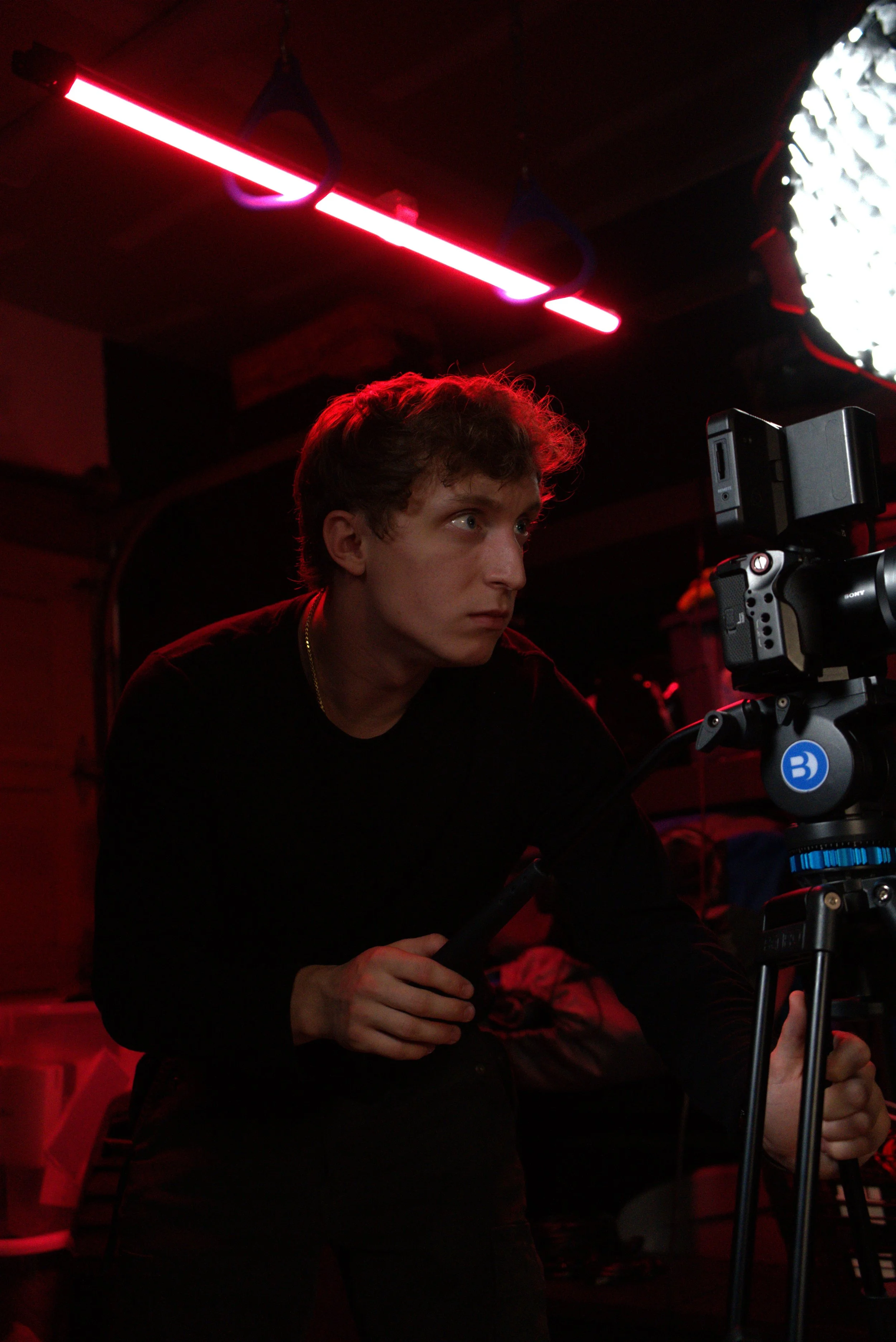 Jaeger, founder of Jaeger Marketing, on set behind a cinema camera